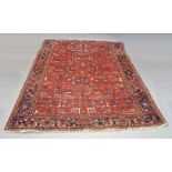 A Hamedan carpet with all-over design in red field, deep blue border, early to mid 20th century,