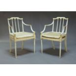 A pair of painted open armchairs, early 20th century, with turned spindle back and arched top rail