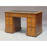 A Victorian Aesthetic oak twin pedestal desk, circa 1890, the top with a leather inset writing