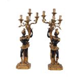 A pair of modern giltwood blackamoor four-light figural lamps, each figure holding aloft gilt-