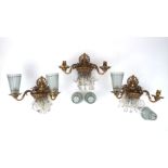 A set of three gilt bronze twin-light wall appliques, 1930s, each with anthemion backplate and