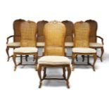 A Dutch style hardwood dining room suite, comprising eight cane-work chairs with padded seats,