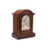 An early 20th century mahogany inlaid bracket clock, glazed door enclosing silvered dial and black