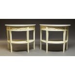 A pair of white painted demi lune console tables, late 20th century, the white marble tops above