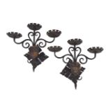 A pair of wrought-iron three-light wall appliques, late 20th century, each with scrollwork supported