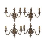 Two pairs of brass twin light wall appliques, 20th Century, each with scrolling arms, 31cm high (