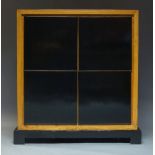 A contemporary elm side cabinet, late 20th century, with four square ebonised doors enclosing