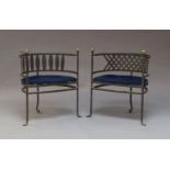 A pair of cast iron tub chairs, late 20th century, each with lattice seats and brass finials, the