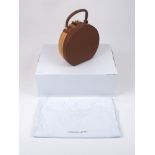 Sparrows Weave: a round wicker and tan leather bag, with top handle and metal clasp and interior