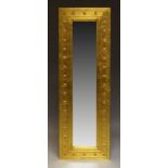 A contemporary gilt full length mirror, of rectangular form with, with raised geometric decoration