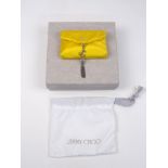 Jimmy Choo: a satin card holder in yellow and silver colour way with magnetic clasp and pendant