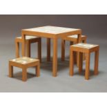 Stephenie Bergman, a contemporary cement and ceramic inset metal table set, with four stools, of