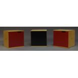 A set of three contemporary laminated birch cupboard units, two with red powder coated steel