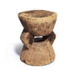 An African carved wooden circular stool, late 19th / early 20th century, 28cm high, 22.5cm