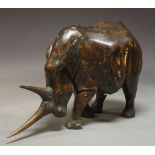 A large wood rhinoceros, 20th century, carved in a stained wood, 112cm long, approx. 77cm high