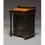 A Chinoiserie black lacquered and parcel gilt davenport, early 20th Century, the top with hinged