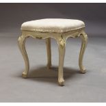 A Louis XV style, 19th century stool, the floral patterned cream upholstered seat on white painted