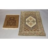 An Afghan rug with 4 medallions in ivory lozenge panel, 164cm long 101cm wide. Turkman rug with five
