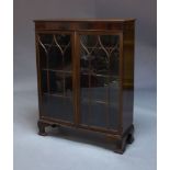 A mahogany glazed display cabinet, 20th Century, with two astragal glazed doors enclosing three