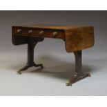 A fine Regency mahogany sofa table, with two frieze drawers and opposing faux drawers, on tapered