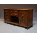 An Edwardian oak sideboard, the rectangular top above two central drawers and recess with single