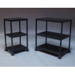 Two black cast iron three tier stands/shelves, 20th Century, each with two removeable wooden