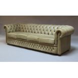 A chesterfield sofa, late 20th Century, upholstered in light khaki leather, on ebonised feet, 80cm