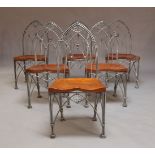 A set of six Gothic style wirework dining chairs, late 20th century, the arched backs above wood