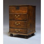 A George III oak narrow chest, the hinged top above three drawers raised on bun feet, 88cm high x