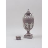 A Wedgwood lilac jasperware 'Dancing Hours' pattern urn and cover, decorated in the Neo-Classical