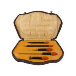 An Art Deco celluloid writing set, the fitted case with pencil, fountain pen, two letter openers and