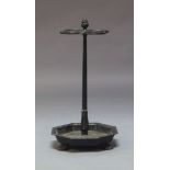 A Victorian black painted cast iron umbrella stand, with floral finial and four circular umbrella