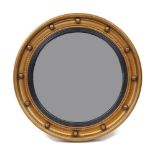 A Regency style giltwood convex mirror, late 20th century, with ebonised reeded slip, 46cm