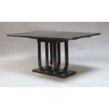 An Art Deco style ebonised dining table, second half 20th Century, the rectangular top with re-