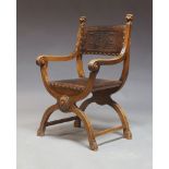 A Continental beech X-framed armchair, early 20th century, with embossed leather back and seat and