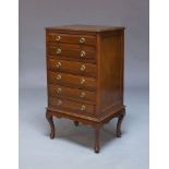 An Edwardian mahogany music cabinet, with six drawers on cabriole type legs to raised pad feet, 92cm