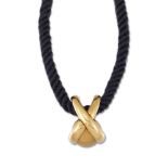 A 'jeux de liens' pendant, by Chaumet, the cross shaped pendant enclosing a textured swiveling ball,