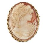 A gold mounted shell cameo, the oval shell cameo depicting a young girl within double twist