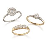 A group of three diamond rings, comprising: a platinum and diamond circular cluster ring, ring