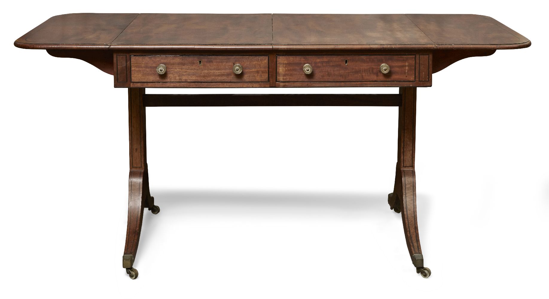 A Regency mahogany sofa table, the rounded rectangular top above two frieze drawers raised on