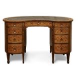 A late Victorian inlaid satinwood kidney shaped kneehole desk, c.1890, with an arrangement of nine