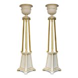 A pair of modern white and gilt painted torchere floor standing lamps, with urns above knopped