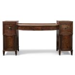 A Regency mahogany sideboard, the sunk centre with three frieze drawers flanked by a cupboard and