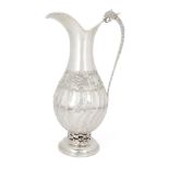 A white metal ewer with zoomorphic handle, stamped 900, the partially fluted body raised on a