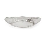 A shaped silver dish, London, 1913, Hukin & Heath, of oval form with fluted quarters, 5cm high, 33cm