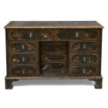 A Queen Anne black japanned side cabinet, c.1720, decorated with chinoiseries, the open kneehole