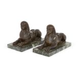 Two bronze models of sphinxes, early 20th century, each mounted on a verde antico marble base,