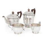 A four piece George V silver tea set, Birmingham, 1931, the teapot 1928, Adie Bros, of panelled