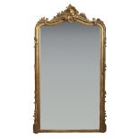 A French giltwood overmantel mirror, with shaped top plate below foliate scroll work and a scroll