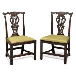 A pair of George III carved mahogany side chairs, possibly Irish, the pierced vase-shaped splats